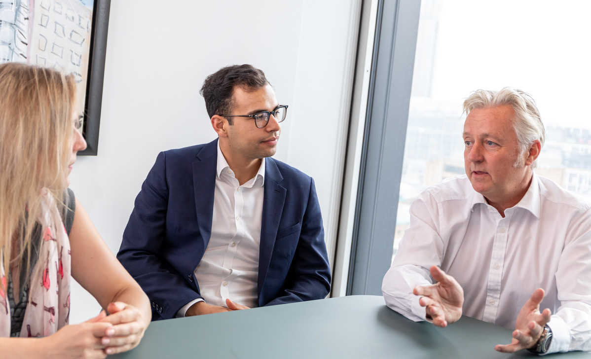 Brokers in deep discussion in a meeting