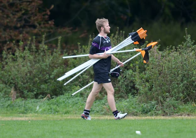 Coach collecting corner flags