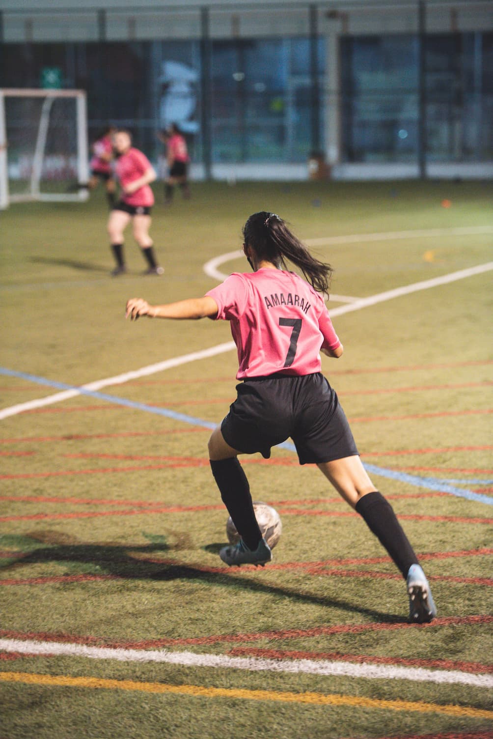 Woman playing football taking a strike