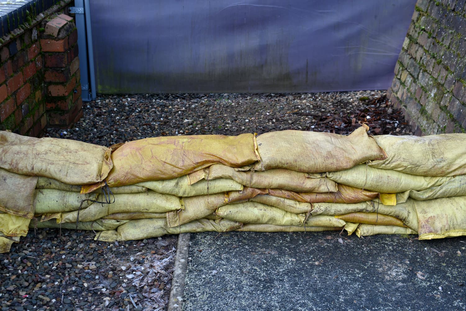 Sandbags laid by external wall as flood defence
