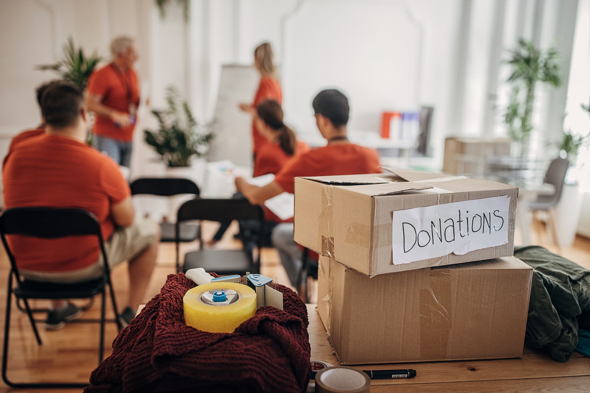 Meeting of charity members with donation boxes