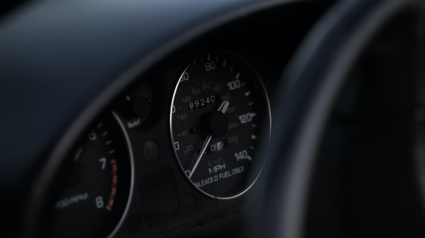 car dashboard showing speedometer at zero
