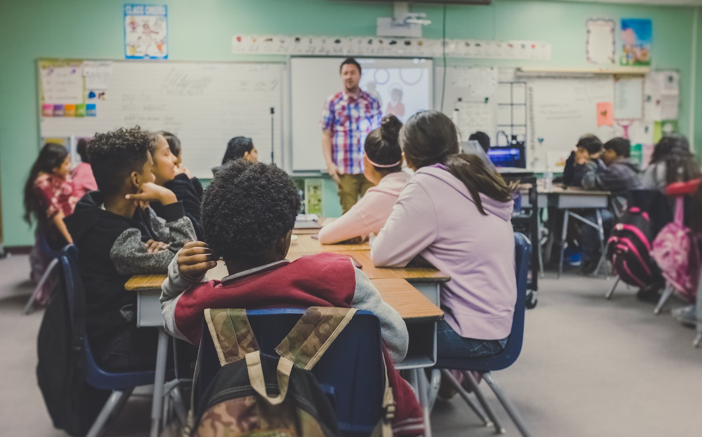 Classroom of young teens with teacher at front