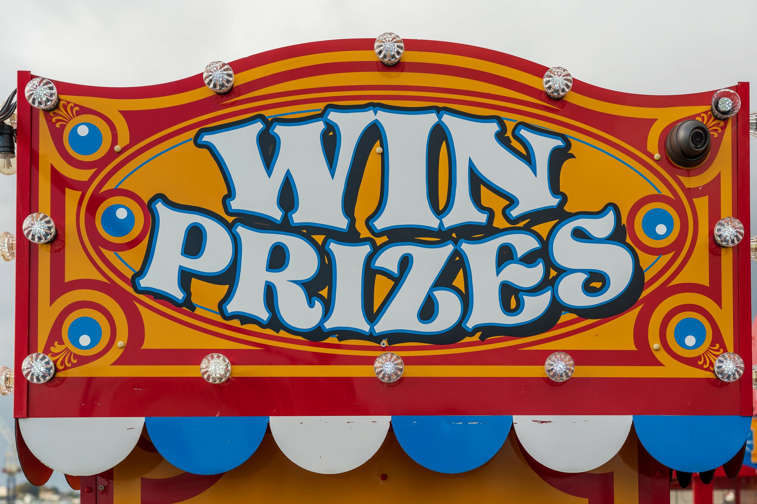 Colourful carnival sign which reads win prizes