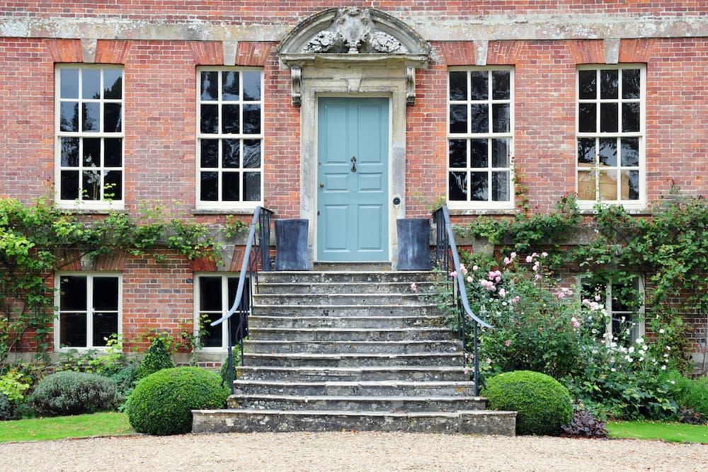 steps up to front door of grand, old, red brick house