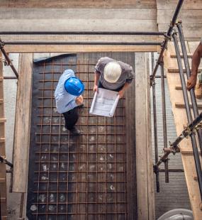 Construction workers and an architect viewed from above