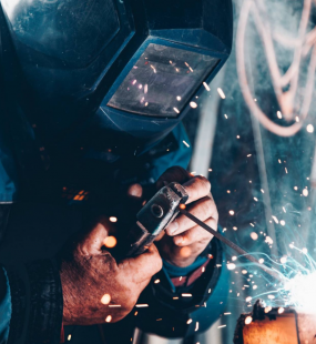 A welder is working, with sparks flying