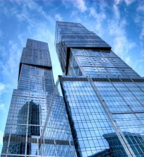 skyscraper with clouds reflected in the glass