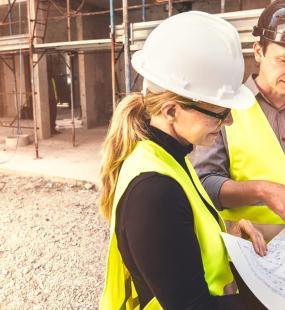 Construction site workers looking at plans