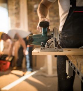 Man using electric saw on a construction site