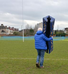Volunteer carrying post padding