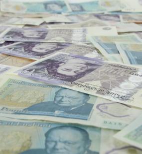 British notes layered up on a table
