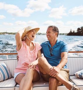 Wealthy couple laughing on a boat