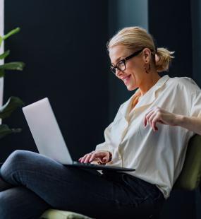 Happy Business Woman Using Laptop Computer In The Office