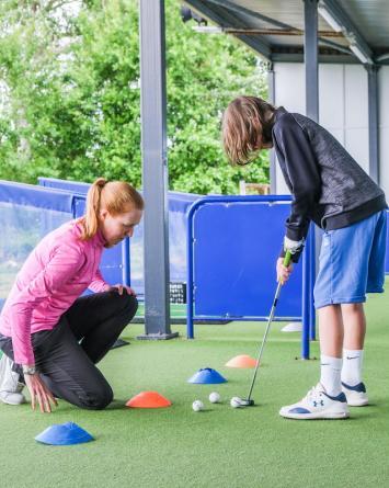 female_pro_pro_teaching_child_putting.jpg