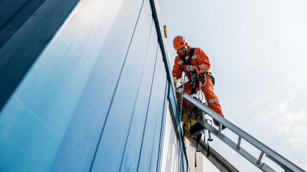 Builders climbing building 