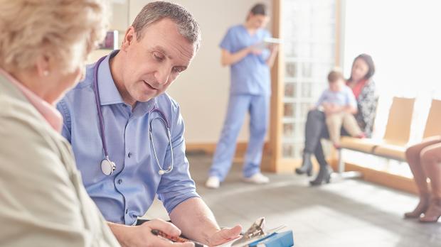 Gp and patient in surgery
