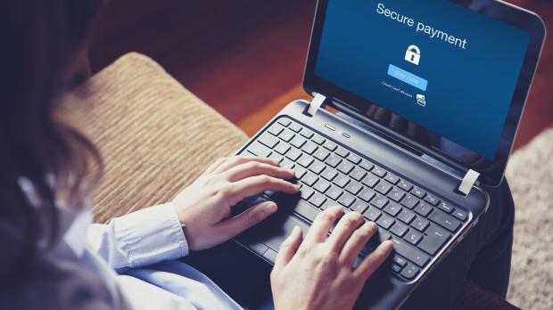 A woman logging into her laptop