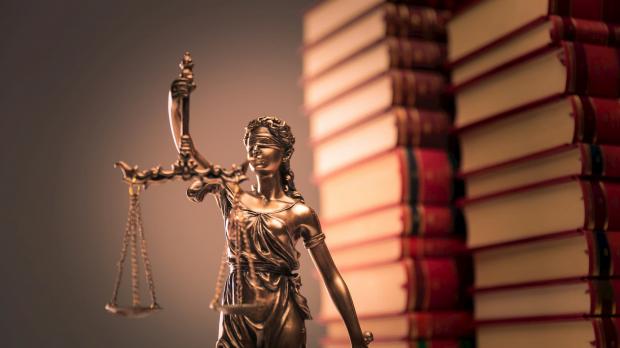 Statue of Justice in front of books