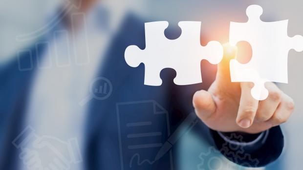 Man pointing to two jigsaw pieces