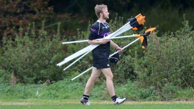 Coach collecting corner flags