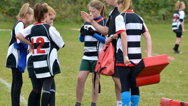 Children having rugby team talk