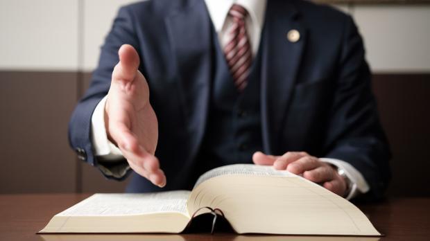Solicitor at desk with large reference book