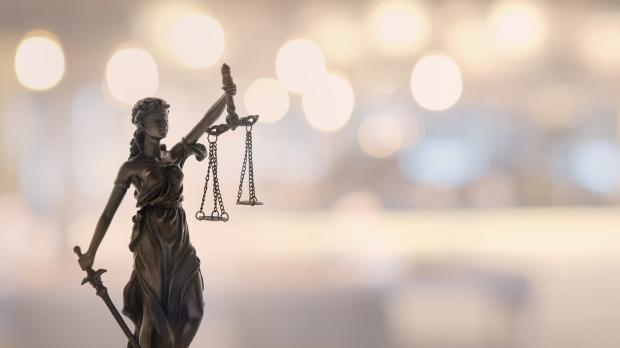 Lady Justice with lights behind