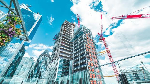 Cranes building high rise offices near the Gherkin in the City of London