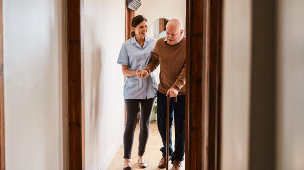 Carer helping an elderly man