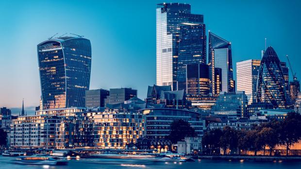 View of London City across the calm Thames from South bank