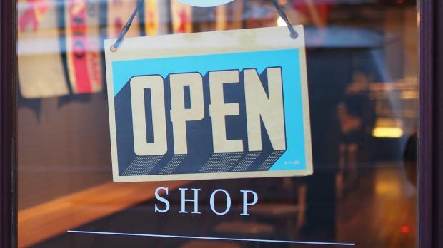 open sign on glass door of shop