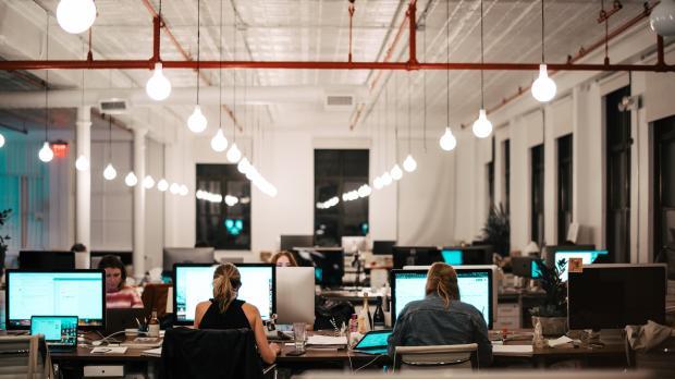 view of interior of modern, open-plan office and people at desks