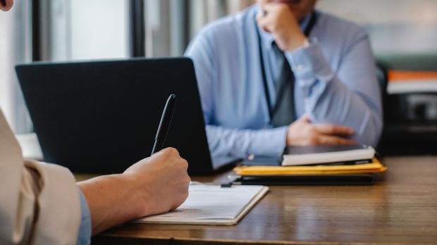 business people having a meeting and taking notes