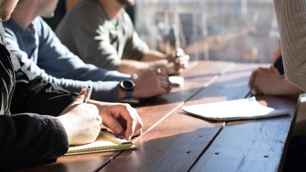 Four people in a business meeting at a table