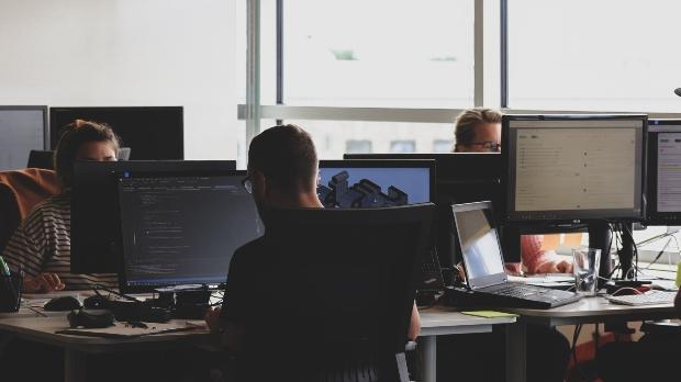 office of business people at desks on computers